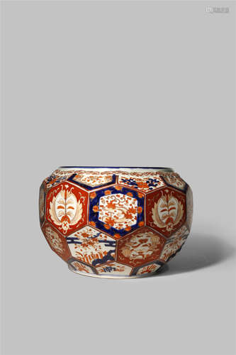 A JAPANESE IMARI JARDINIERE EARLY 20TH CENTURY The bulbous body with a faceted surface and decorated