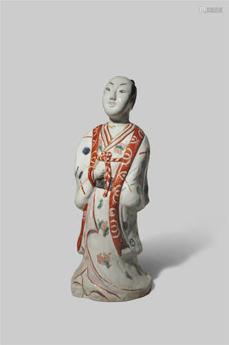 A LARGE JAPANESE IMARI MODEL OF A MAN C.1700 Depicted standing and wearing a short coat over his