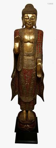 Large carved giltwood figure of a standing Buddha with right hand in Abhaya mudra and left hand in