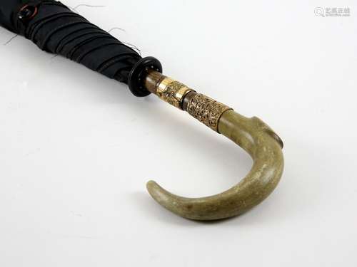 Early 20th century rhino horn handled and gilt metal mounted umbrella, 85cm long,