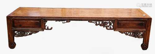 Chinese hardwood low table with two drawers, on carved supports and scrolling foliage decoration,