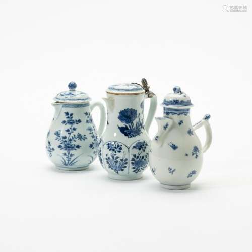 Three Chinese blue and white ewers and covers