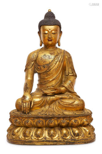 A large gilt copper alloy figure of Shakyamuni