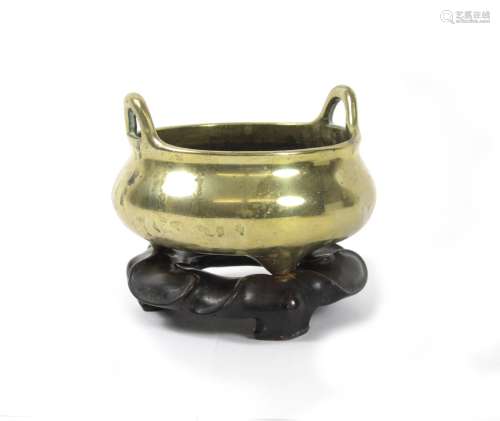 Six character Xuande mark but later A bronze tripod incense burner on hardwood stand
