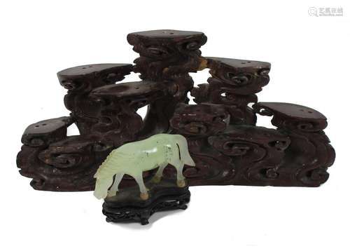 A soapstone stand together with a hardstone horse