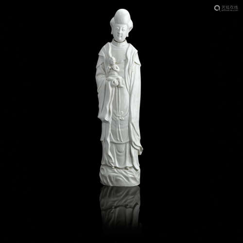 Late 17th/early 18th century A tall blanc-de-chine figure of Guanyin and boy