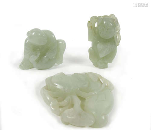 Two jade carvings of boys and another of lotus