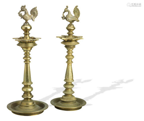 India, 19th/20th century Two brass lamp stands with hamsa finials