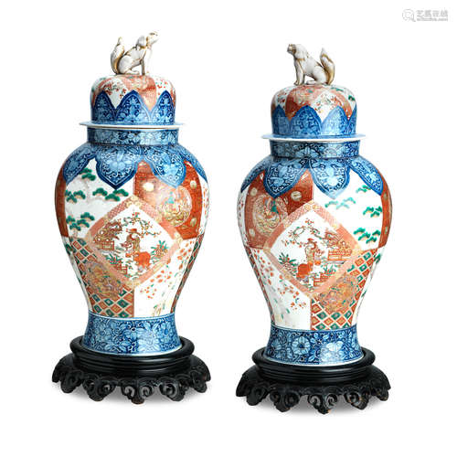 Meiji era (1868-1912) A pair of large Imari floor vases with covers and wooden stands