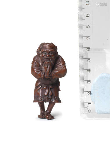 By Ouchi Sosui (1911-1972), Showa era (1926-1989), 20th century A wood figure netsuke of an Ainu