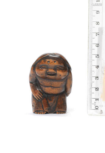 Edo period (1615-1868), early-mid 19th century A wood netsuke of Okame