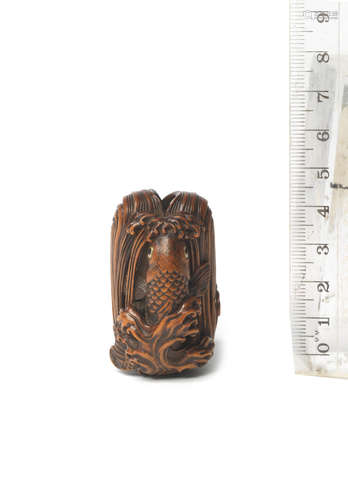 By Masanao, Yamada, Ise province, Edo period (1615-1868), 19th century A wood netsuke of a carp ascending a waterfall