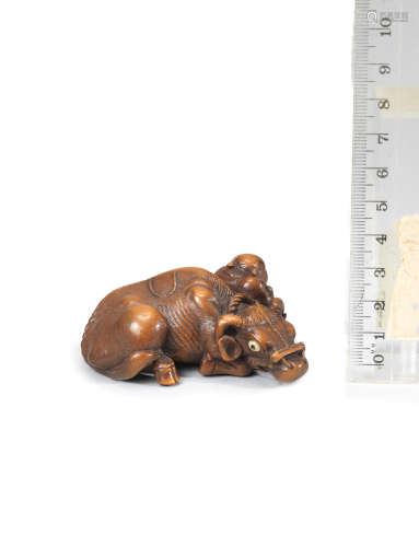 By Ryuhan, Edo period (1615-1868), late 18th/early 19th century A rare wood netsuke of an oxherd and ox