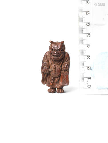 By Ouchi Sosui (1911-1972), Showa era (1926-1989), 20th century A wood netsuke of Oni Nenbutsu