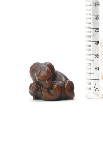 By Masakazu, Nagoya, Edo period (1615-1868), mid-19th century A wood netsuke of a bitch with two pups