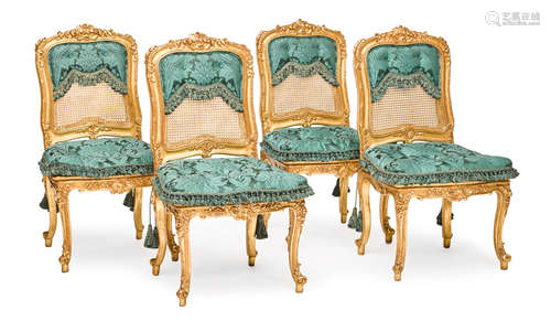 20th century A set of four Louis XV style carved giltwood upholstered and caned side chairs