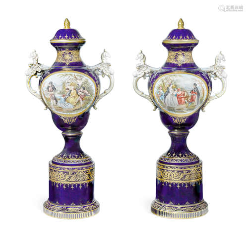 First quarter 20th century A pair of Vienna style porcelain two handled covered vases on separate pedestals