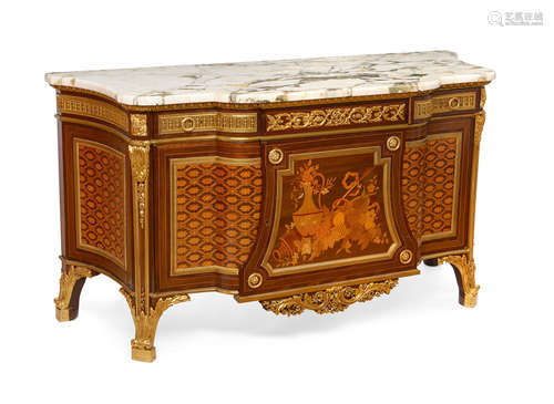 After a model by Jean-Henri RiesenerEarly 20th century A Louis XV/XVI transitional style gilt bronze mounted marquetry and parquetry commode