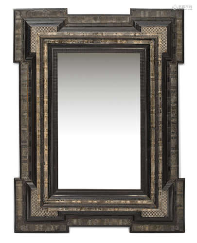 A Flemish Baroque style brass mounted ebonized wood mirror