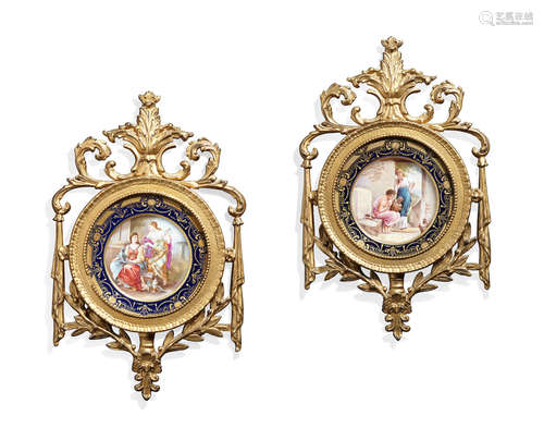 Early 20th century A pair of Austrian porcelain plates in giltwood frames