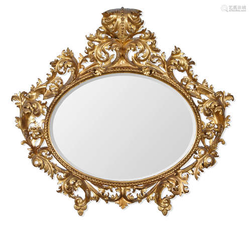 Late 19th century An Italian Baroque style giltwood oval mirror