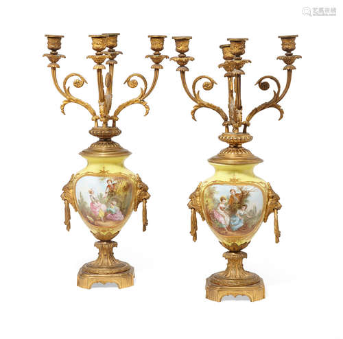 Circa 1900 A pair of French gilt bronze mounted yellow porcelain four light candelabra