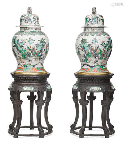 A pair of monumental Chinese porcelain lidded jars on gilt bronze bases on carved and paint decorated hardwood stands