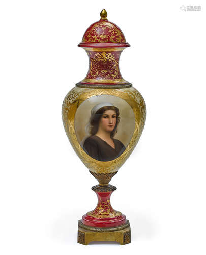 A gilt bronze mounted parcel gilt red and cream ground Sèvres style porcelain lidded urn