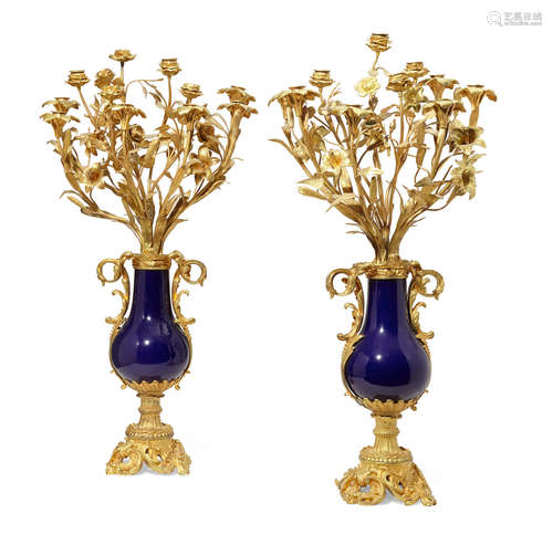 Second half 19th century A pair of Louis XVI style gilt bronze mounted blue porcelain urn form eleven light candelabra