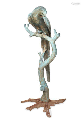 A green patinated cast bronze model of a parrot on a branch