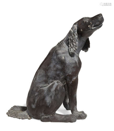 A patinated cast iron model of a seated dog