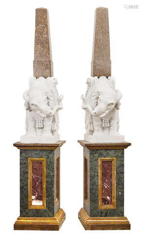 A monumental pair of Italian marble elephant form obelisks on stands