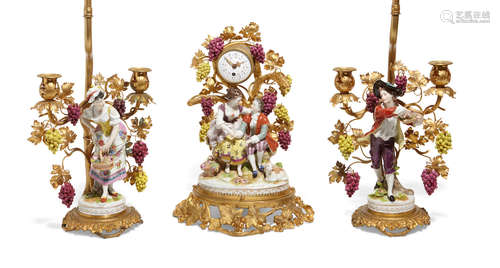 Early 20th century A French gilt bronze mounted porcelain three piece figural clock garniture