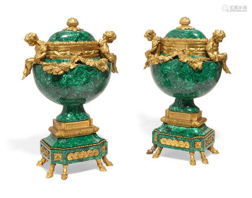 A pair of Louis XVI style gilt bronze and malachite veneered urns