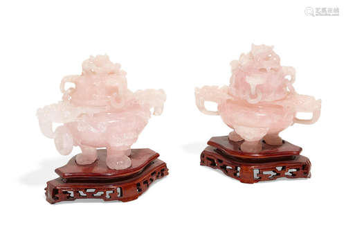 A pair of Chinese rose quartz covered two handled censors on hardwood stands