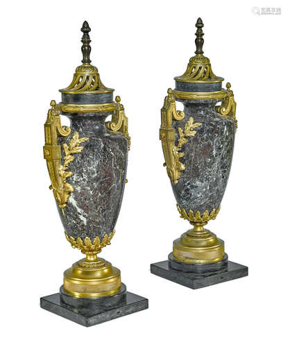 Early 20th century A pair of French gilt bronze mounted marble urns