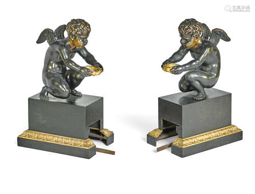 19th century A pair of Empire Style patinated and gilt bronze kneeling putti chenets with connecting adjustable fire fender