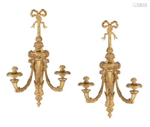 A pair of Louis XVI gilt bronze three branch wall lights