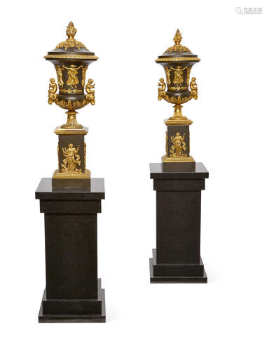 A pair of Empire style gilt and patinated bronze covered urns