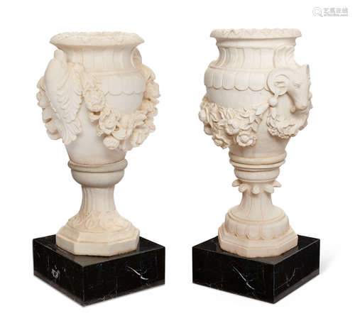 Two Neoclassical style carved white marble garden urns on square plinths