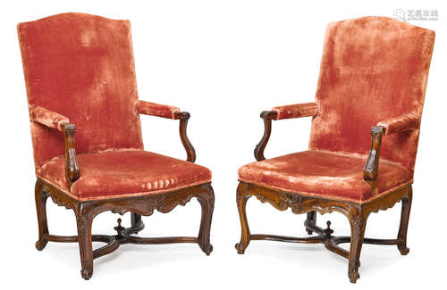 Early 18th century A pair of Régence carved fruitwood armchairs