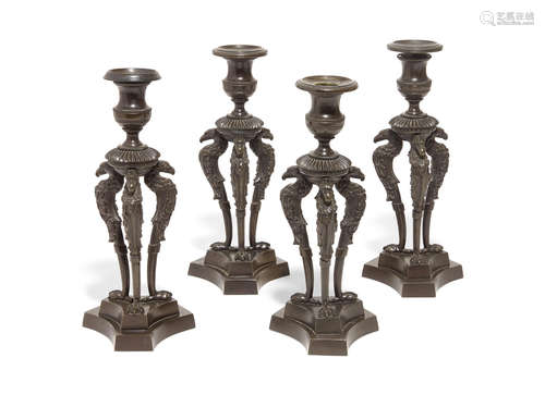 Second quarter 19th century A set of four Charles X bronze candlesticks