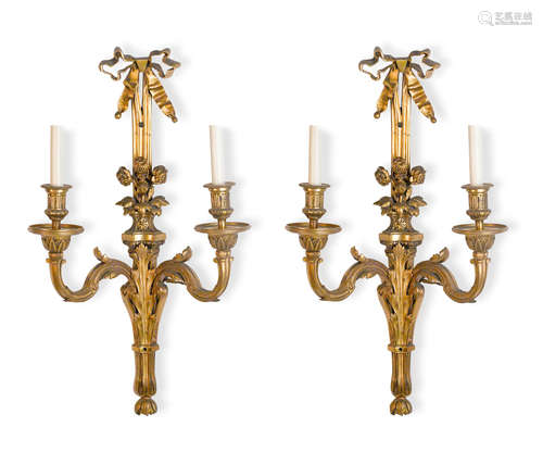 A pair of gilt bronze two light wall sconces