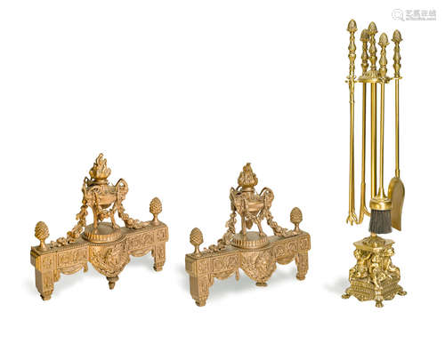 19th/20th century  A pair of Louis XVI style gilt bronze chenets and a Neoclassical style set of four brass fire tools on stand