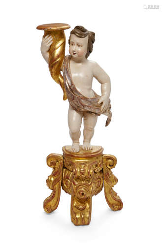 An Italian Baroque style parcel gilt and polychrome decorated figural pricket