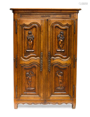 Late 18th century A French Provincial Carved Oak and Fruitwood Armoire