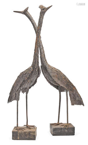 A pair of painted metal standing cranes