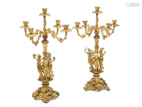 Second quarter 19th century A pair of Louis Philippe gilt bronze five light figural candelabra