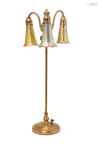 Early 20th century A Tiffany Studios Favrile glass and gilt bronze telescoping Three light Lily lamp