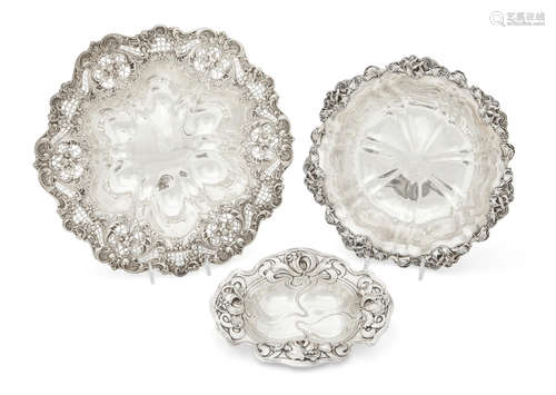 by various makers, early 20th Century  Three American sterling silver bowls with floral borders